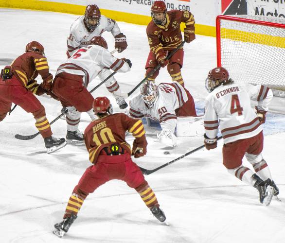 UMass goalie Michael Hrabal (30) attempts to cover the puck during the college hockey game against Boston College at the Mullins Center, Saturday, Feb. 15, 2025, in Amherst.
