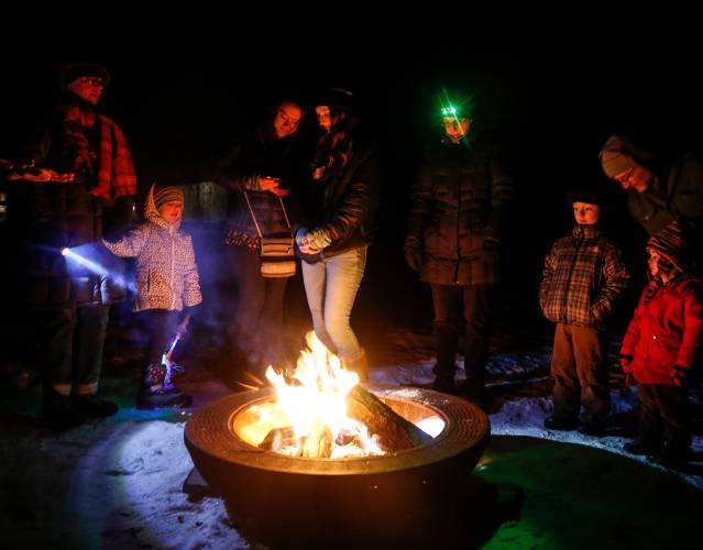 Attendees of the 2018 Winter HooPla warm up by a fire in the Shelburne Falls Trolley Museum railyard. The ninth annual event returns Feb. 22.