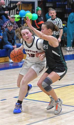 Frontier’s Skyler Steele drives on a Manchester Essex defender during the Redhawks’ MIAA Division 4 Round of 32 victory at Goodnow Gymnasium in South Deerfield Thursday.