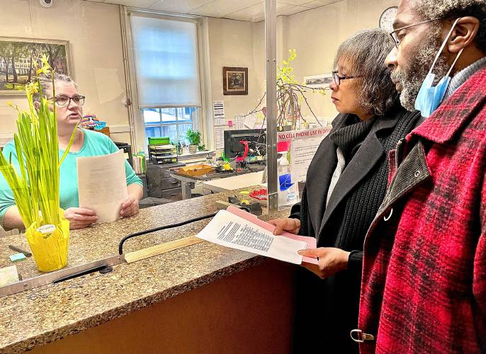 Greenfield housing activists Joan Marie Jackson and Mitchell Speight hand a petition to regulate accessory dwelling units to City Clerk Kathryn Scott. Greenfield housing activists Joan Marie Jackson and Mitchell Speight hand a petition to regulate accessory dwelling units to City Clerk Kathryn Scott.