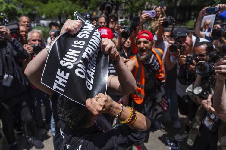 A supporter of former President Donald Trump and an anti-Trump protester fight outside Manhattan Criminal Court, Thursday, May 30, 2024, in New York. (AP Photo/Julia Nikhinson)