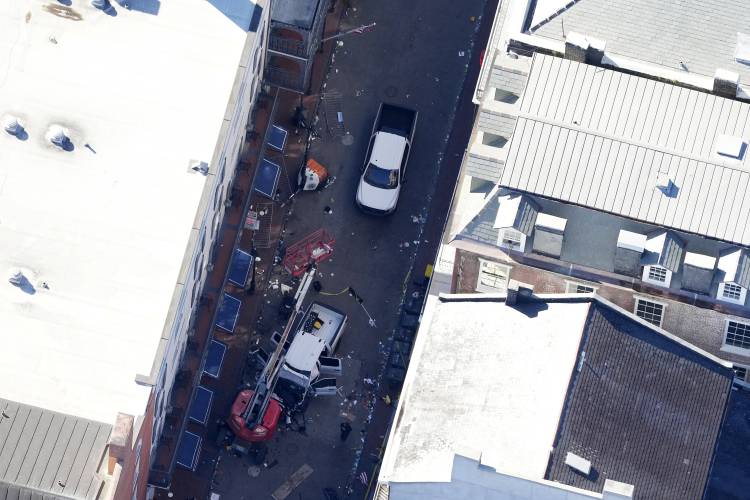 Investigators work the scene after a person drove a vehicle into a crowd earlier on Canal and Bourbon Street in New Orleans, Wednesday, Jan. 1, 2025. (AP Photo/Gerald Herbert)