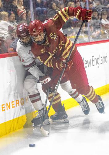 UMass center Lucas Mercuri, left, and Boston College defenseman Aram Minnetian, right, compete for the puck during the college hockey game at the Mullins Center, Saturday, Feb. 15, 2025, in Amherst.