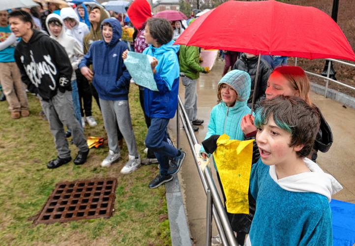 Val Mazzei, front right, an Amherst Regional Middle School student, stands with others during a protest outside the UMass Campus Center where a hearing of the Joint Committee on Ways and Means was held Monday morning. 