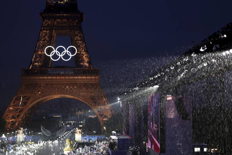 A general view as rain falls in front of the Eiffel Tower, in Paris, France, during the opening ceremony of the 2024 Summer Olympics, Friday, July 26, 2024. in Paris, France, during the opening ceremony of the 2024 Summer Olympics, Friday, July 26, 2024. (Pascal Le Segretain/Pool Photo via AP)
