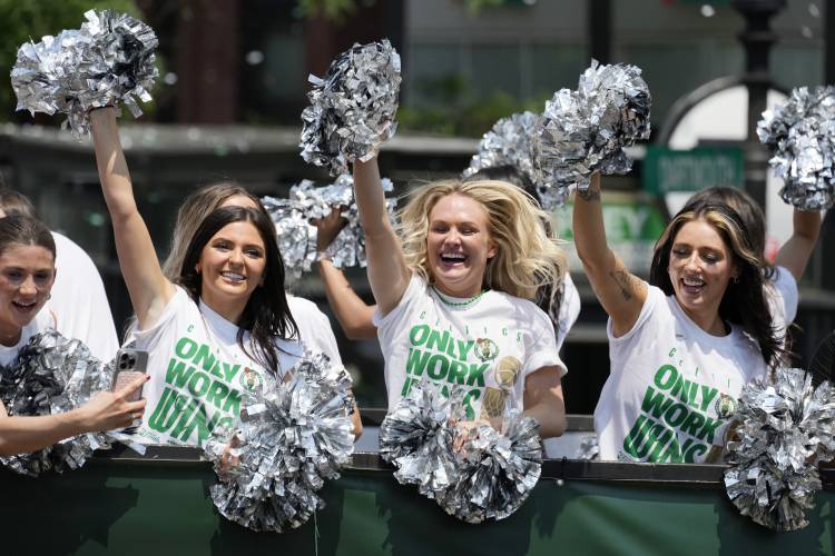 Boston Celtics cheerleaders celebrate the team's NBA basketball championship win during a duck boat parade Friday, June 21, 2024, in Boston. (AP Photo/Michael Dwyer)