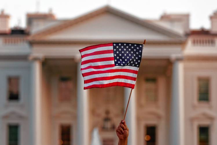 A flag is waved outside the White House, in Washington, D. C. A flag is waved outside the White House, in Washington, D. C.