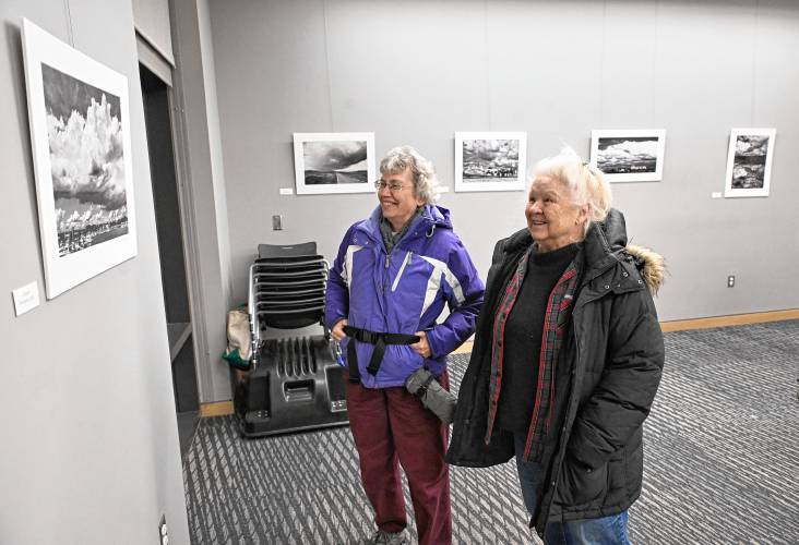 Visitors view photos from photographer Paul Jablon’s show, “Clouds in Shades of Grey,” on display at the Greenfield Public Library.