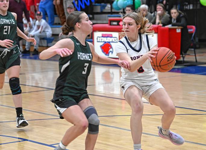 Frontier’s Whitney Campbell looks to pass past Manchester Essex defender Lily Oliver during the Redhawks’ MIAA Division 4 Round of 32 victory at Goodnow Gymnasium in South Deerfield Thursday.