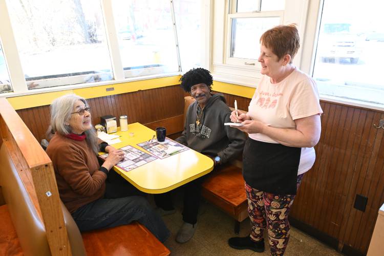 Waitress Denise Milkey takes an order from customers Divya Shinn of Gill and Carlos Anderson of Montague at the Shady Glen Diner on Avenue A in Turners Falls.