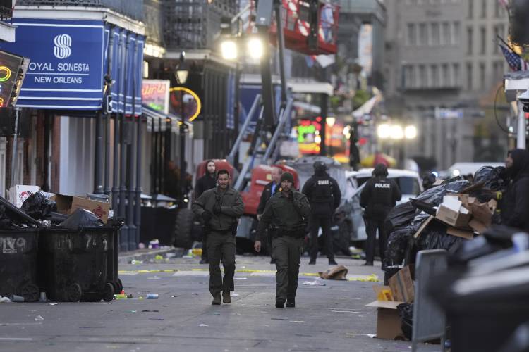 Emergency services attend the scene after a vehicle drove into a crowd on New Orleans' Canal and Bourbon Street, Wednesday Jan. 1, 2025. (AP Photo/Gerald Herbert)