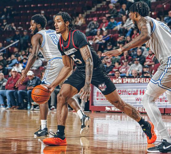UMass forward Daniel Rivera (5) probes in the lane looking for a teammate to pass to during the first half of the Minutemen’s game against Saint Louis on Tuesday night at Mullins Center in Amherst.