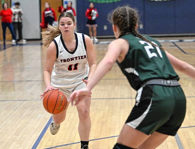 Frontier’s Claire Kirkendall is defended by Manchester Essex’s Isabelle Donnelian Valade during the Redhawks’ MIAA Division 4 Round of 32 victory at Goodnow Gymnasium in South Deerfield Thursday.