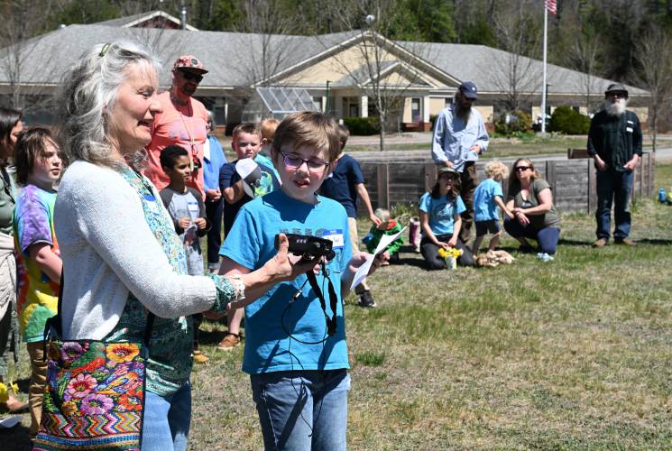 Clare Greene of the Warwick Community School Foundation and sixth grade student Silas Smith read an elder Hopi saying welcoming those attending a belated Earth Day celebration at Warwick Community School on April 30.