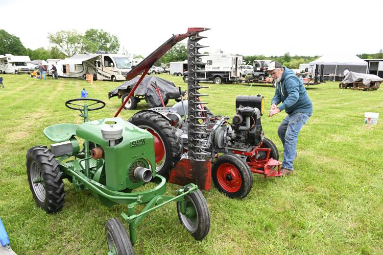 Russell Miller of Contoocook, New Hampshire, pulls a cord to start his 1947 Gibson single-piston tractor at the 49th annual Gas Engine Show, Flea Market & Craft Fair at Pratt Field in Bernardston on Friday.
