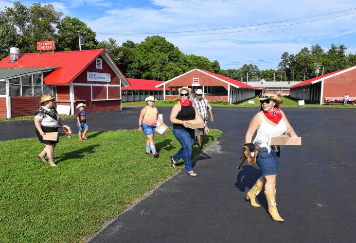 Another group of cowgirls and cowboys head out with their boxes to collect food at the stops on the rodeo-themed Big Brothers Big Sisters Point 5K fundraiser on Thursday at the Franklin County Fairgrounds.