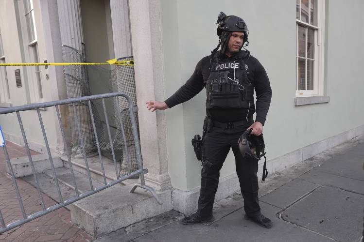A member of the emergency services attends the scene after a vehicle drove into a crowd on New Orleans' Canal and Bourbon Street, Wednesday Jan. 1, 2025. (AP Photo/Gerald Herbert)