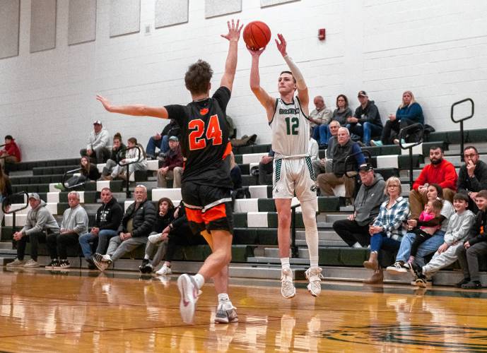 Greenfield's Caleb Thomas (12) attempts a shot over South Hadley's Griff Soderbaum (24) during the high school basketball game at Greenfield High School, Wednesday, Feb. 5, 2025, in Greenfield.