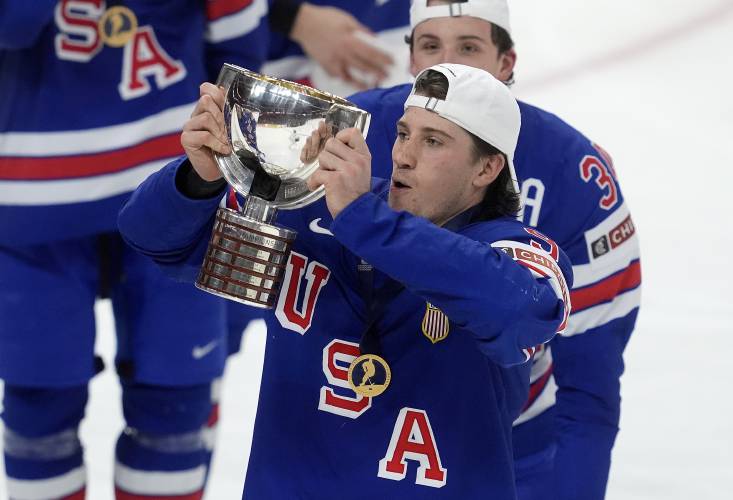 United States forward Ryan Leonard (9) hoists the trophy following their IIHF World Junior Hockey Championship gold medal game win over Finland in Ottawa, Ontario, Sunday, Jan. 5, 2025. 