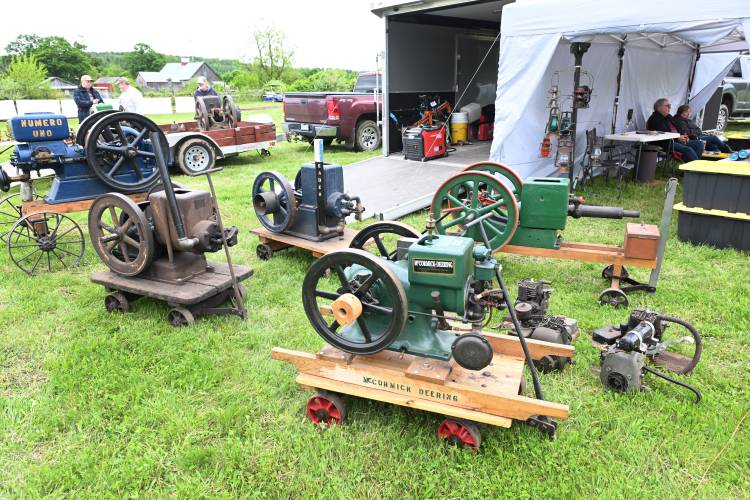 Several single-piston engines are on display at the 49th annual Gas Engine Show, Flea Market & Craft Fair at Pratt Field in Bernardston on Friday. The heavy iron wheels help keep the engine running with their momentum.