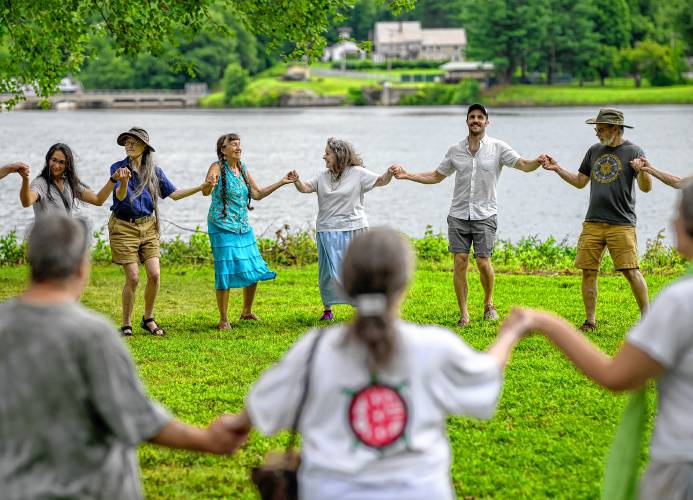 Dancers hold hands during the Pocumtuck Homelands Festival, celebrating Native American art, music and cultures at Unity Park in Turners Falls on Saturday.