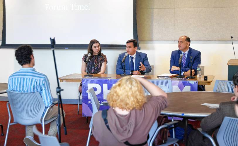 From left, Julia Mathis, legislative aide for state Rep. Lindsay Sabadosa, state Rep. Danillo Sena and state Sen. Jamie Eldridge answer questions during Tuesday’s forum at the University of Massachusetts Amherst.