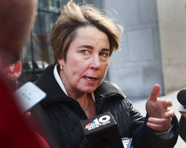 Gov. Maura Healey speaks to the media after a radio interview at the Boston Public Library.