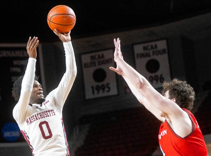 UMass guard Jaylen Curry (0) attempts a shot over Davidson during the college basketball game at the Mullins Center, Wednesday, Feb. 12, 2025, in Amherst.