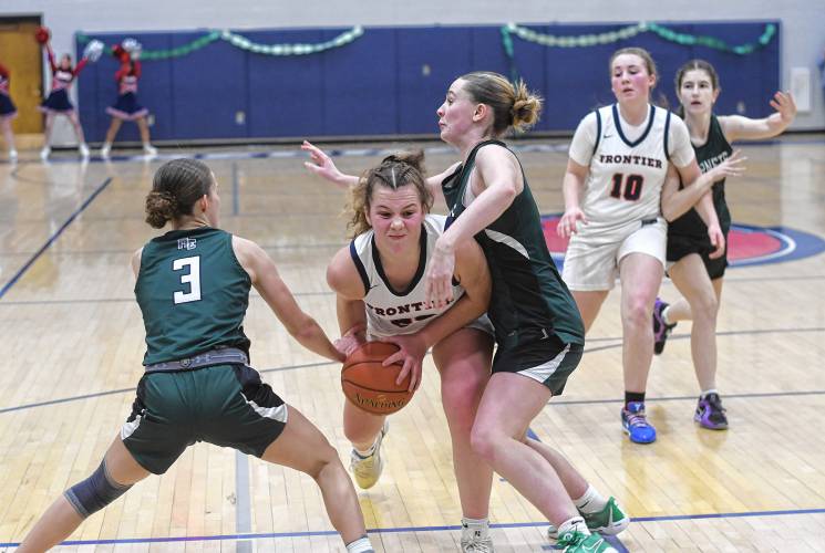 Frontier’s Harper Modestow tries to split Manchester Essex defenders during the Redhawks’ MIAA Division 4 Round of 32 victory at Goodnow Gymnasium in South Deerfield Thursday.