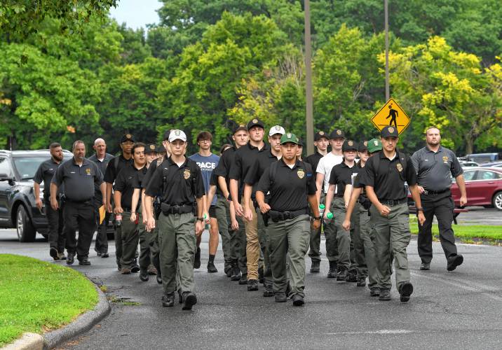Participants and advisers for the Franklin County Police Cadet Program march in formation at Greenfield Community College on Wednesday.