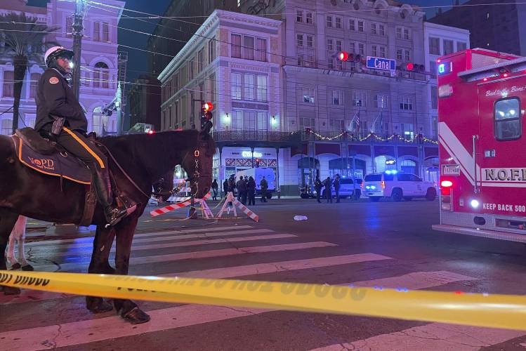 A mounted police officer arrives on Canal Street after a vehicle drove into a crowd earlier in New Orleans, Wednesday Jan. 1, 2025. (AP Photo/Kevin McGill)