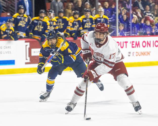 UMass center Kenny Connors (17) controls the puck during Saturday’s hockey game against Merrimack at the Mullins Center in Amherst.