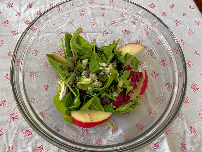 I added some blue cheese crumbles to my greens for creaminess, plus some apple slices for crunch. Feel free to make your salad with your own favorite ingredients.