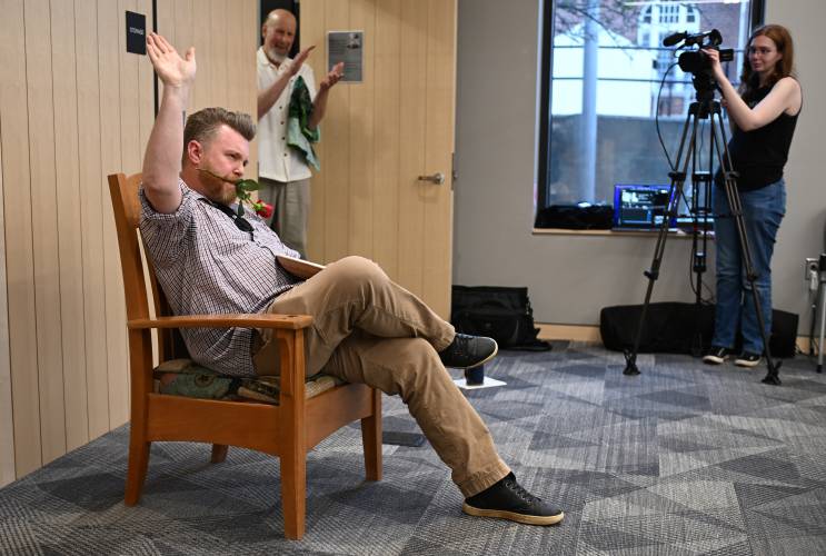 Christian Drake sits in the Poet’s Seat chair at the Greenfield Public Library on Tuesday after winning first place in the adult category of the Poet’s Seat Poetry Contest with his poem, “Necropsy of a Spirit Deer.”