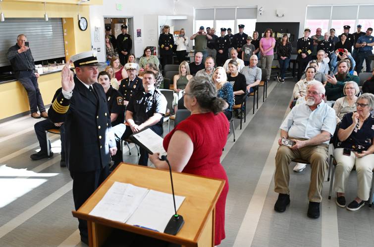 Greenfield City Clerk Kathy Scott swears in new Greenfield Deputy Fire Chief Peter McIver Wednesday at the John Zon Community Center. The position of deputy chief has been vacant since the departure of Ed Jarvis more than five years ago.