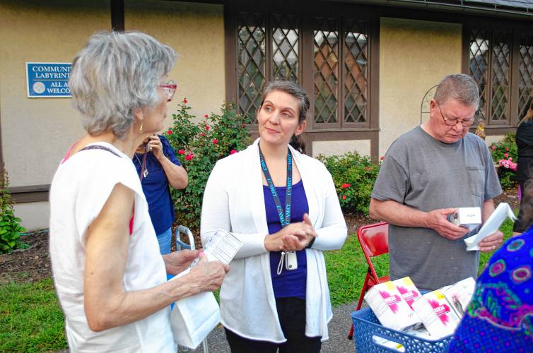 Nicole St. Hilaire explains how to administer naloxone to reverse an opioid overdose to attendee Mary Rose.