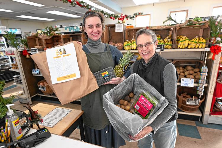 Quabbin Harvest Food Co-op interim Team Leader Camille Bedaw and Treasurer Cathy Stanton with a food share.