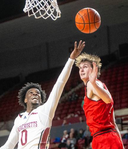 UMass guard Jaylen Curry (0) attempts a layup past Davidson forward Reed Bailey, right, during the college basketball game at the Mullins Center, Wednesday, Feb. 12, 2025, in Amherst.