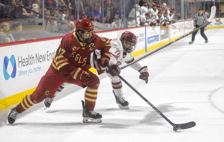 Boston College defenseman Aram Minnetian (17) and UMass right wing Aydar Suniev, right, compete for the puck during the college hockey game at the Mullins Center, Saturday, Feb. 15, 2025, in Amherst.