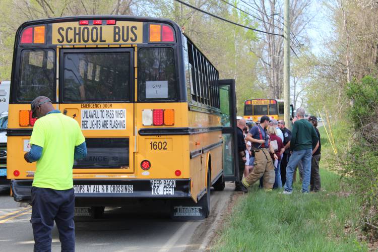 First responders evacuate a Gill school bus after it was involved in a minor collision with a recycling truck on Main Road on Friday afternoon.