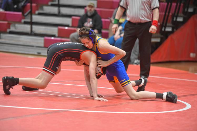 Athol’s John Robertson (left) competes against Mohawk Trail’s Wade Purington on Tuesday at Mallet Gymnasium. 