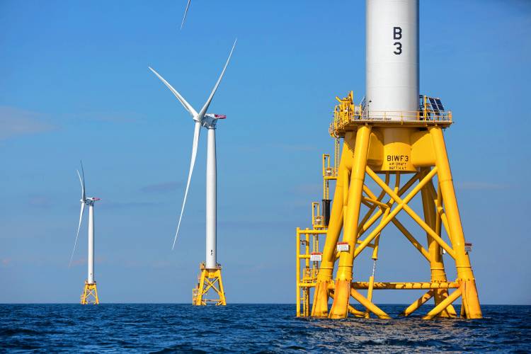 In this Aug. 15, 2016 file photo, three of Deepwater Wind’s five turbines stand in the water off Block Island, Rhode Island, the nation’s first offshore wind farm. In this Aug. 15, 2016 file photo, three of Deepwater Wind’s five turbines stand in the water off Block Island, Rhode Island, the nation’s first offshore wind farm.