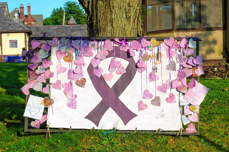 A poster with purple hearts commemorates those lost to opioid overdose at a vigil in Greenfield on Friday.
