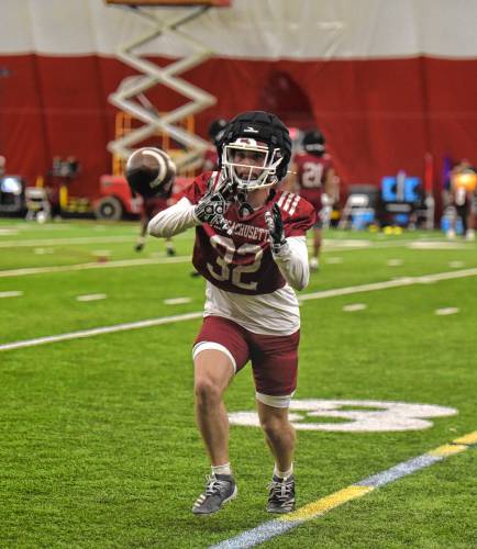 UMasss defensive back Jose Touron (32) catches a pass in a drill during the Minutemen’s first football practice of the spring season on Monday morning in Amherst.
