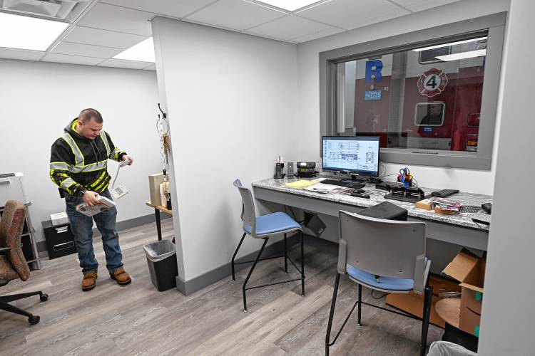Aaron Budine of the Bernardston Fire Department helps set up the dispatch area in the new Bernardston Fire Station at 167 Northfield Road.