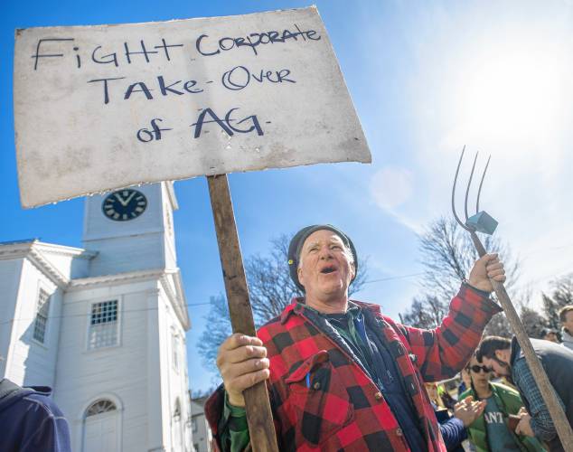 Colrain resident Jonathan Lagreze cheers during an “Attack on Small Farms” rally Sunday in front of Hadley Town Hall. Some 300 farmers from throughout the region were protesting proposed cuts and funding freezes involving the U.S. Department of Agriculture.