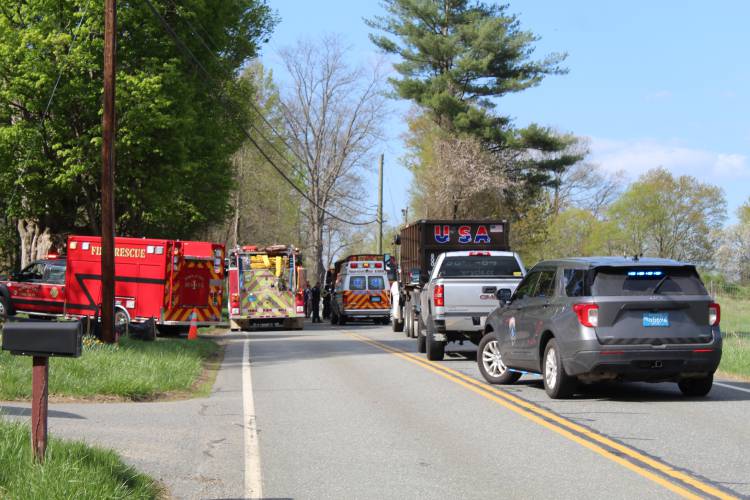 First responders assist at the scene of a collision between a Gill school bus and a recycling truck on Main Road on Friday afternoon.