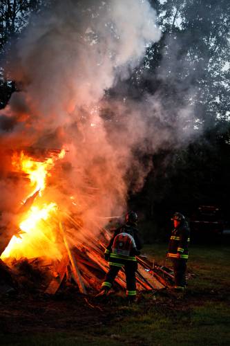 Firefighters light the annual bonfire at the Montague Center Ballfield in 2019. This year’s event will be held Wednesday, July 3, starting at 6:30 p.m.