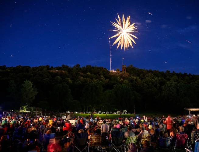 Hundreds gather at Beacon Field to watch fireworks launch from Poet’s Seat Tower in Greenfield in 2018. This year’s fireworks have been postponed to Sunday due to the forecast of rain on the original event date.