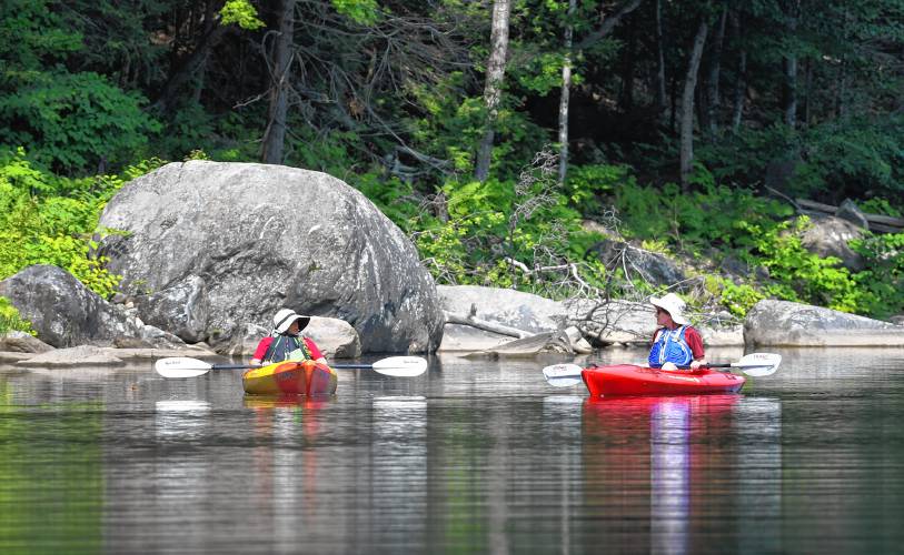 Northfield resident Denise Paquin and Greenfield resident Emily Koester pause for a chat as they enjoy a morning paddle on the Deerfield River in Shelburne.